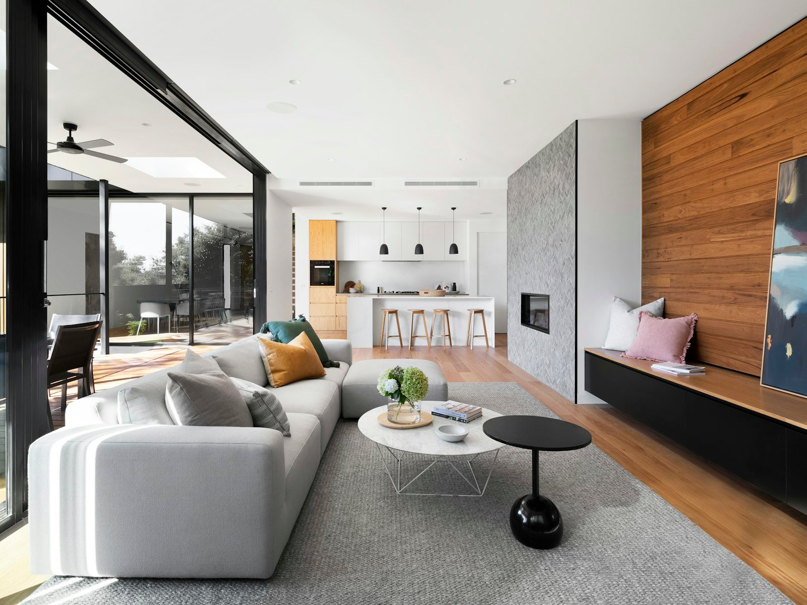 A bright interior with fitted joinery and a view through to the next room.